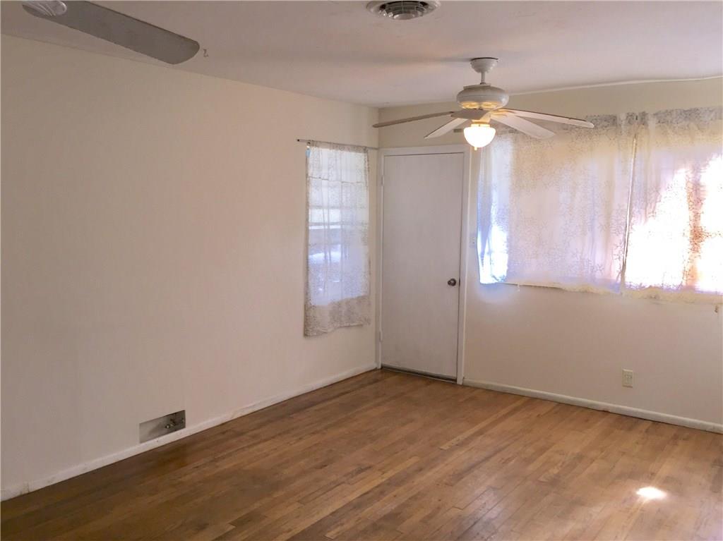 1614 Elmira Road Austin, TX 78721 - Photo 16 of 23 Spare room with a ceiling fan and wood-type flooring