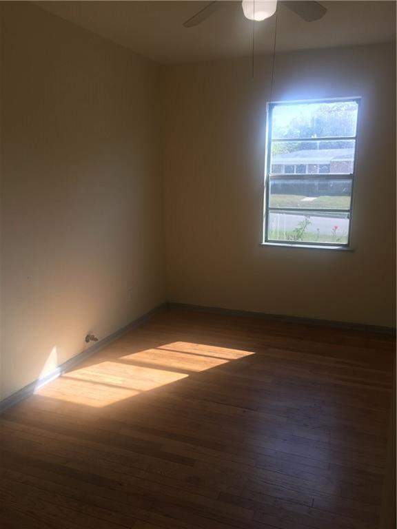 1614 Elmira Road Austin, TX 78721 - Photo 20 of 23 Unfurnished room with dark wood-style flooring and a ceiling fan