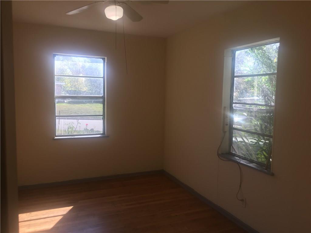 1614 Elmira Road Austin, TX 78721 - Photo 23 of 23 Spare room featuring dark wood-style floors and a ceiling fan
