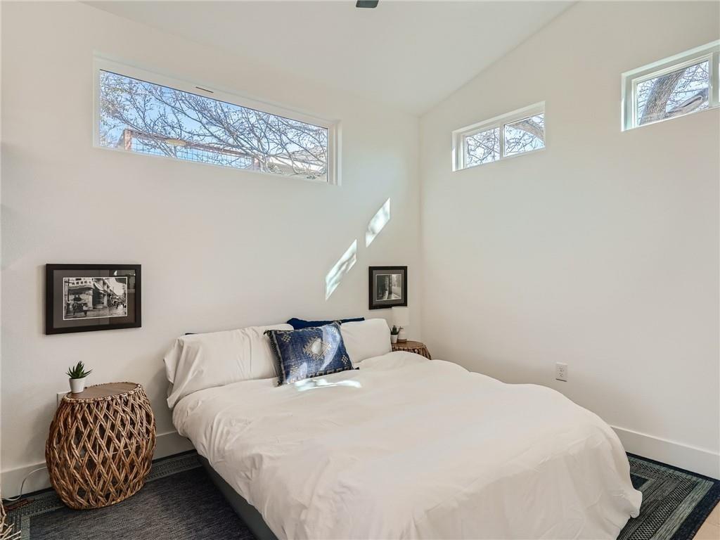 1614 Elmira Road Austin, TX 78721 - Photo 8 of 23 Bedroom with baseboards and lofted ceiling