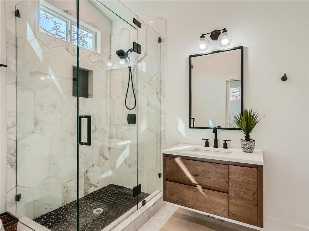 1614 Elmira Road Austin, TX 78721 - Photo 9 of 23 Full bath with a marble finish shower and vanity