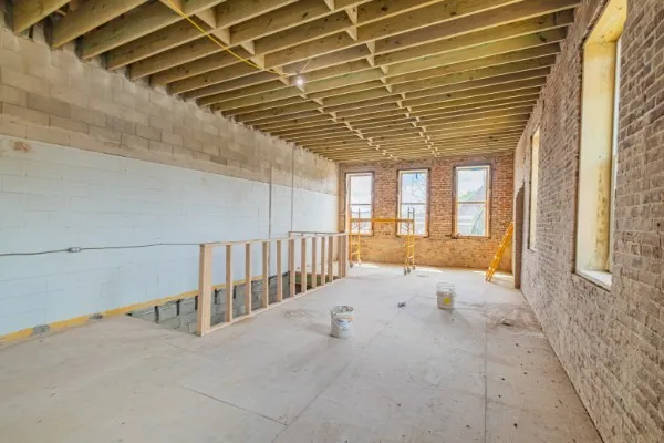 a roof deck with couch and potted plants