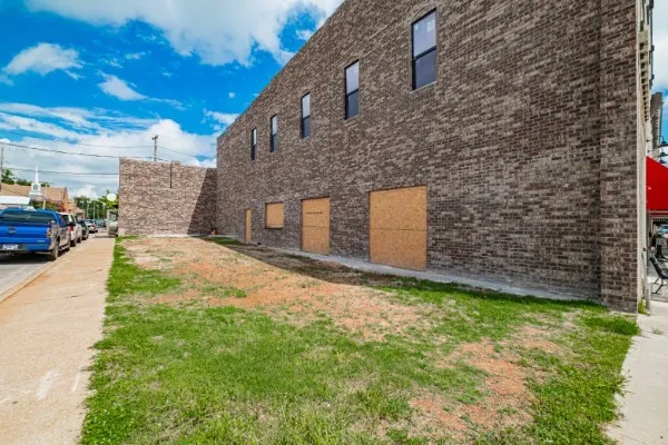 a view of a brick house with many windows