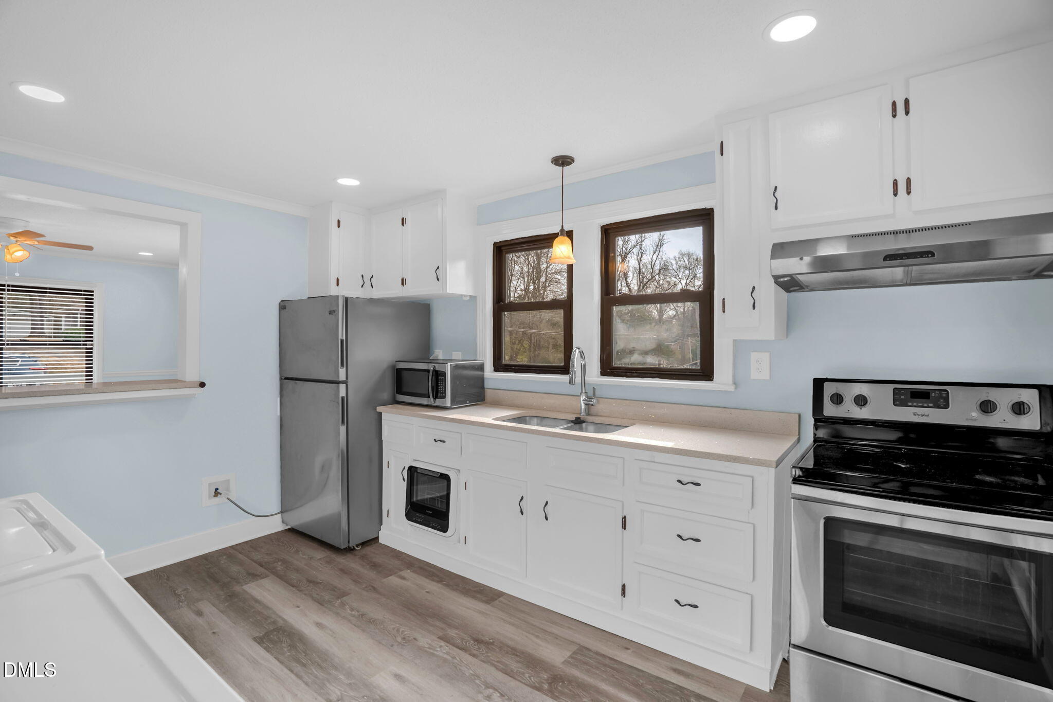 2807 Beck Road Durham, NC 27704 - Photo 13 of 35 a kitchen with a refrigerator a stove a sink and a window