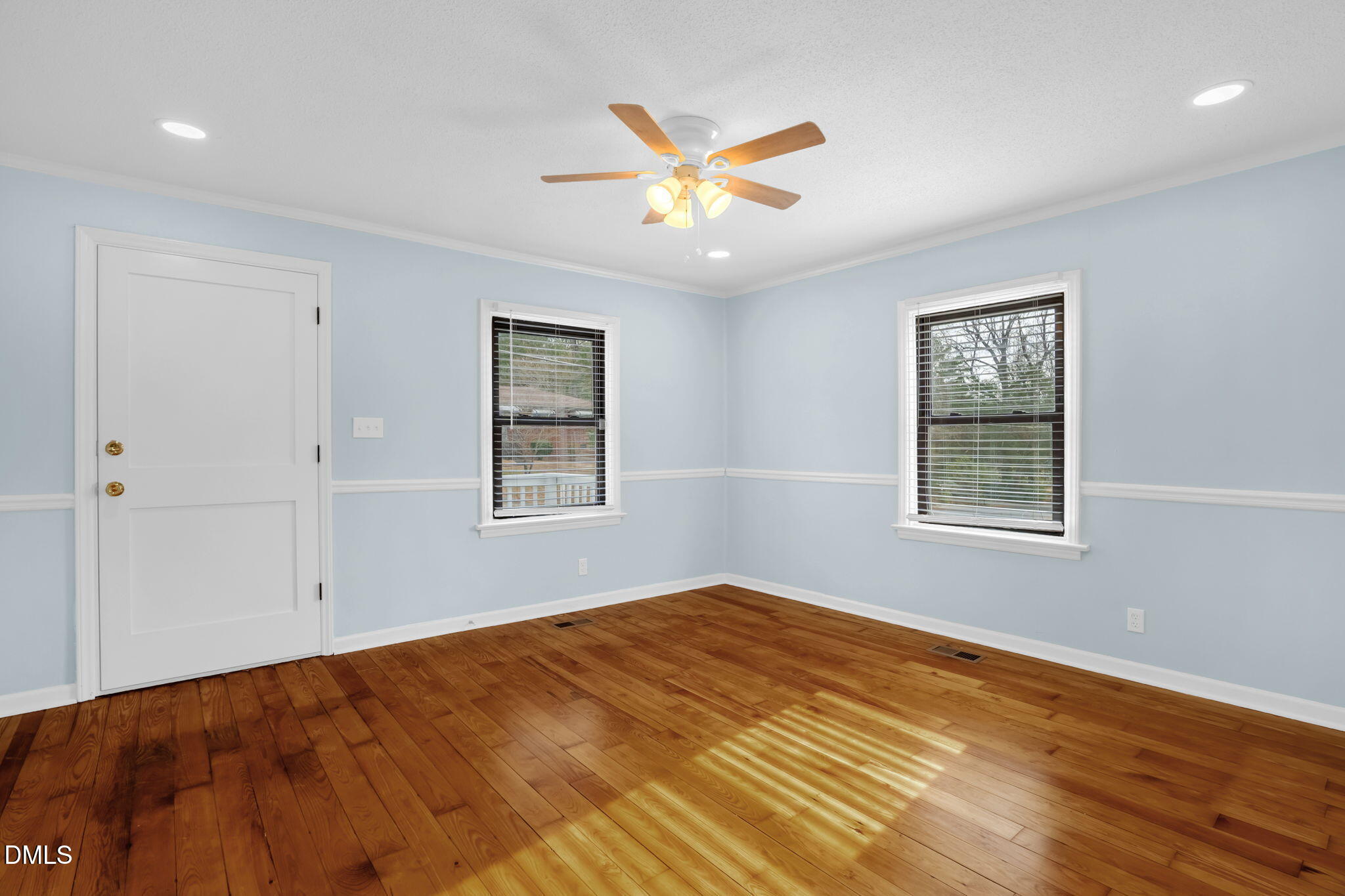 2807 Beck Road Durham, NC 27704 - Photo 18 of 35 a view of a big room with wooden floor and windows