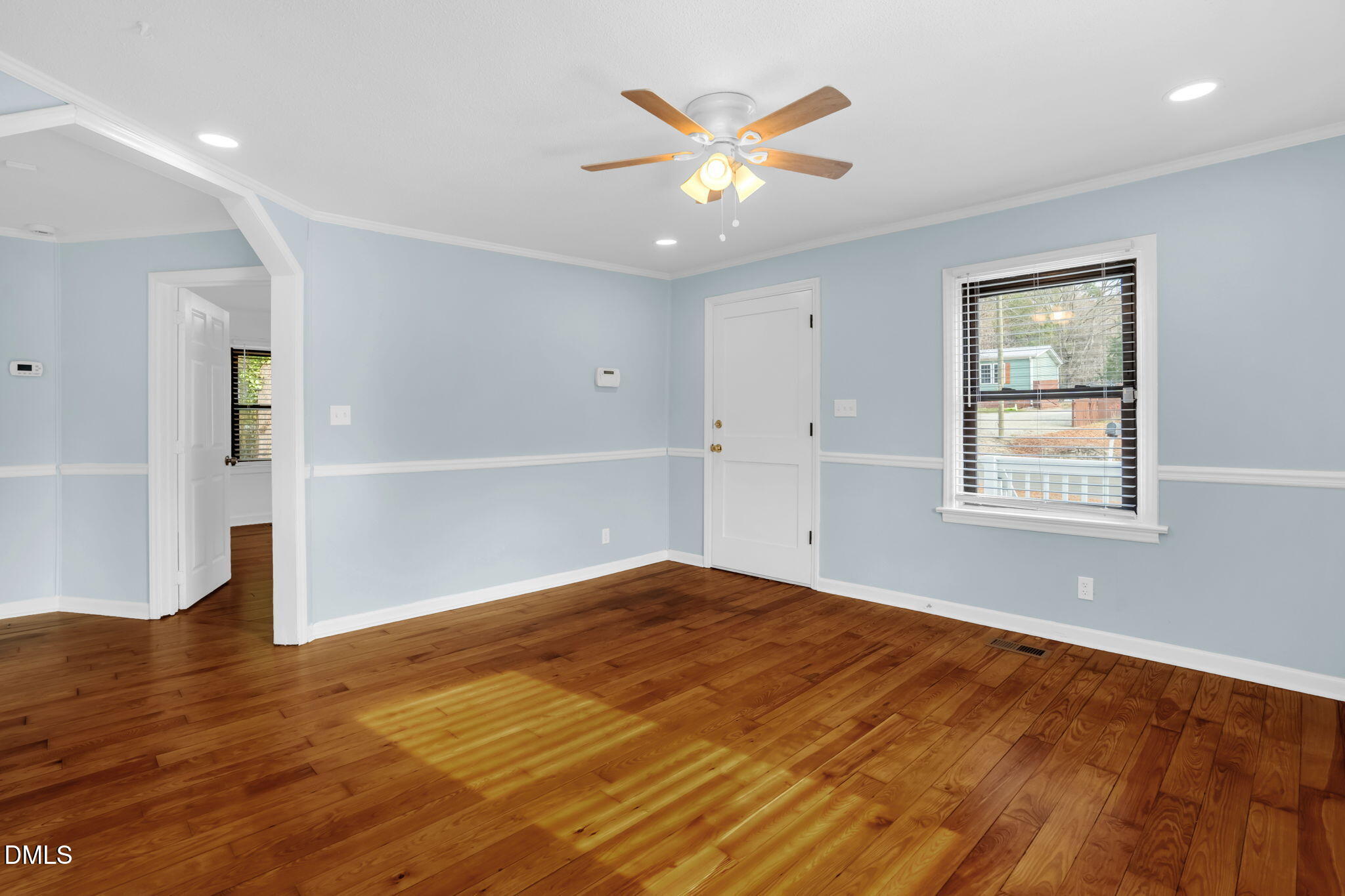 2807 Beck Road Durham, NC 27704 - Photo 19 of 35 an empty room with wooden floor and windows