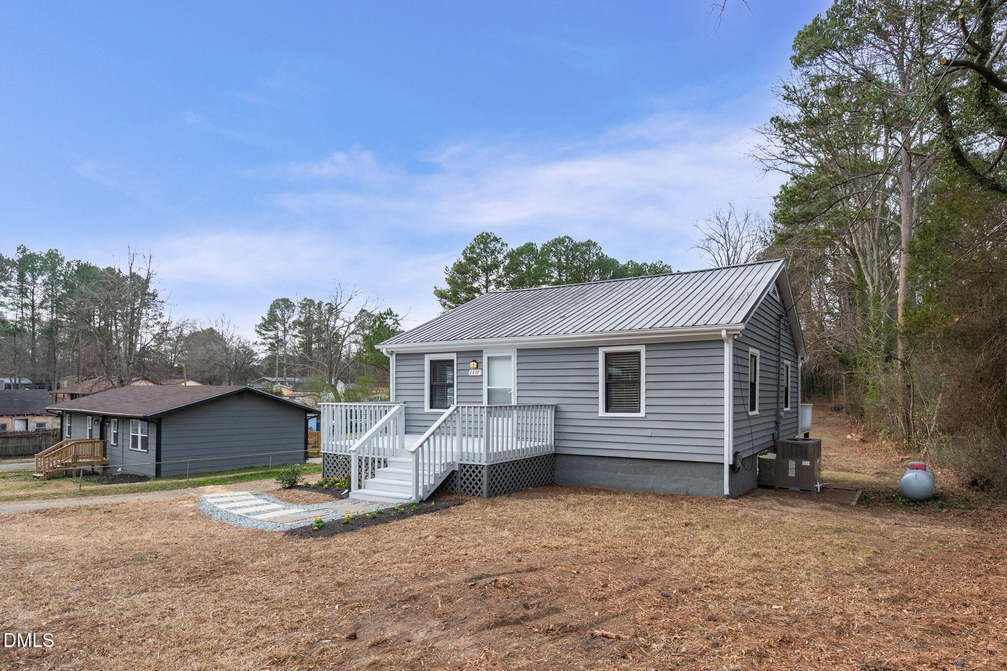 2807 Beck Road Durham, NC 27704 - Photo 2 of 35 a view of a house with a yard and garage