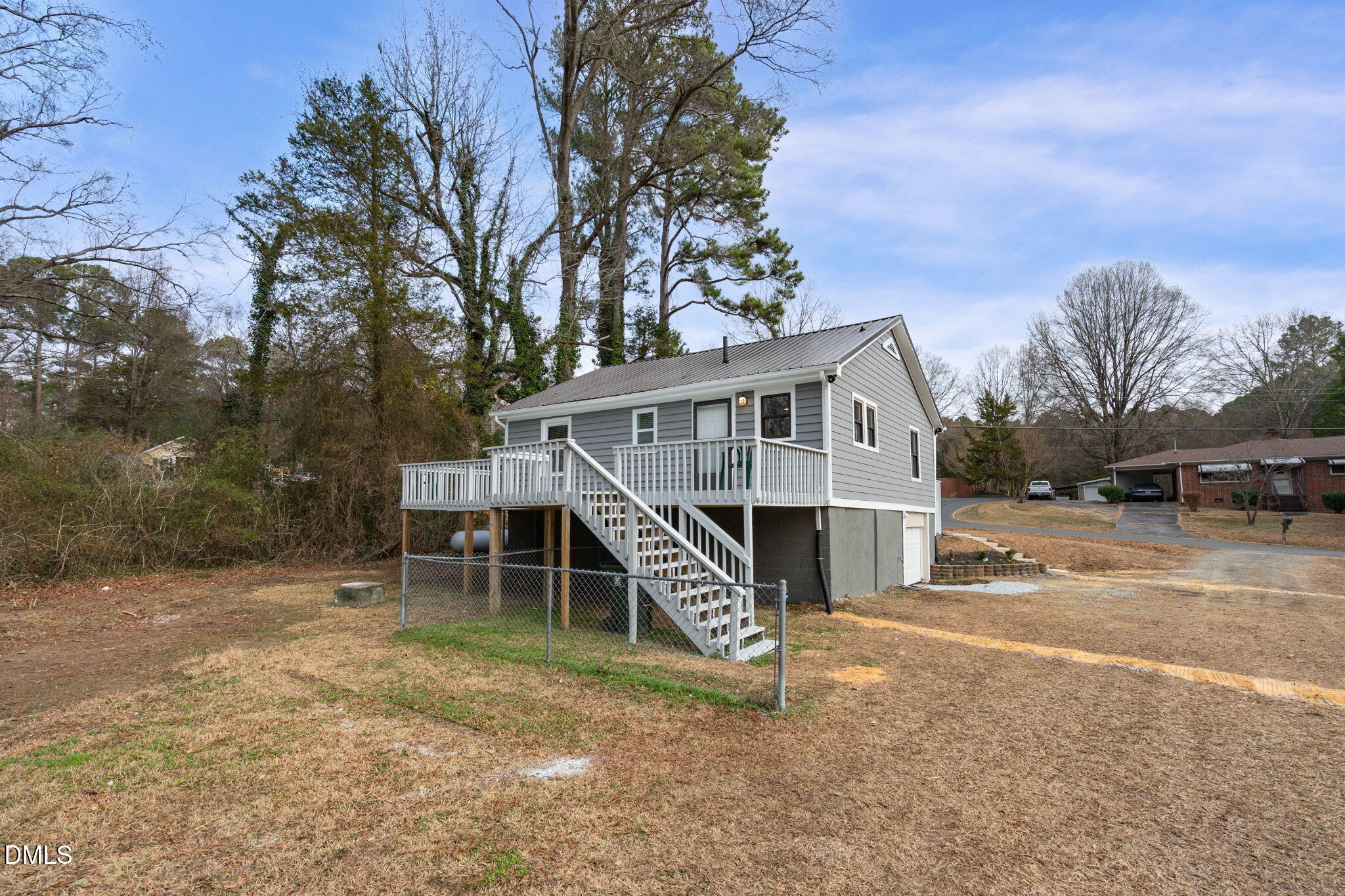 2807 Beck Road Durham, NC 27704 - Photo 5 of 35 a view of a house with a yard and a wooden deck