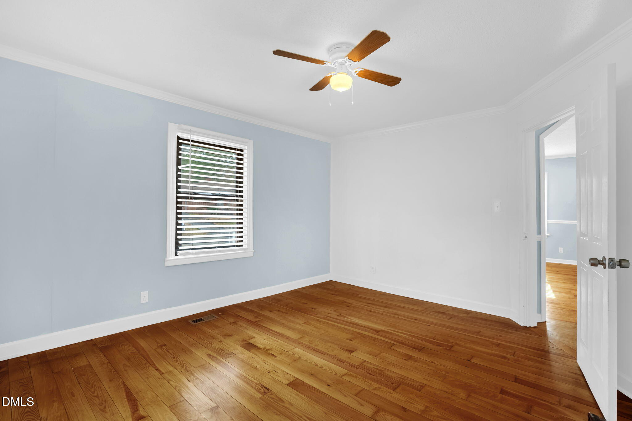 2807 Beck Road Durham, NC 27704 - Photo 8 of 35 a view of an empty room with wooden floor and a window