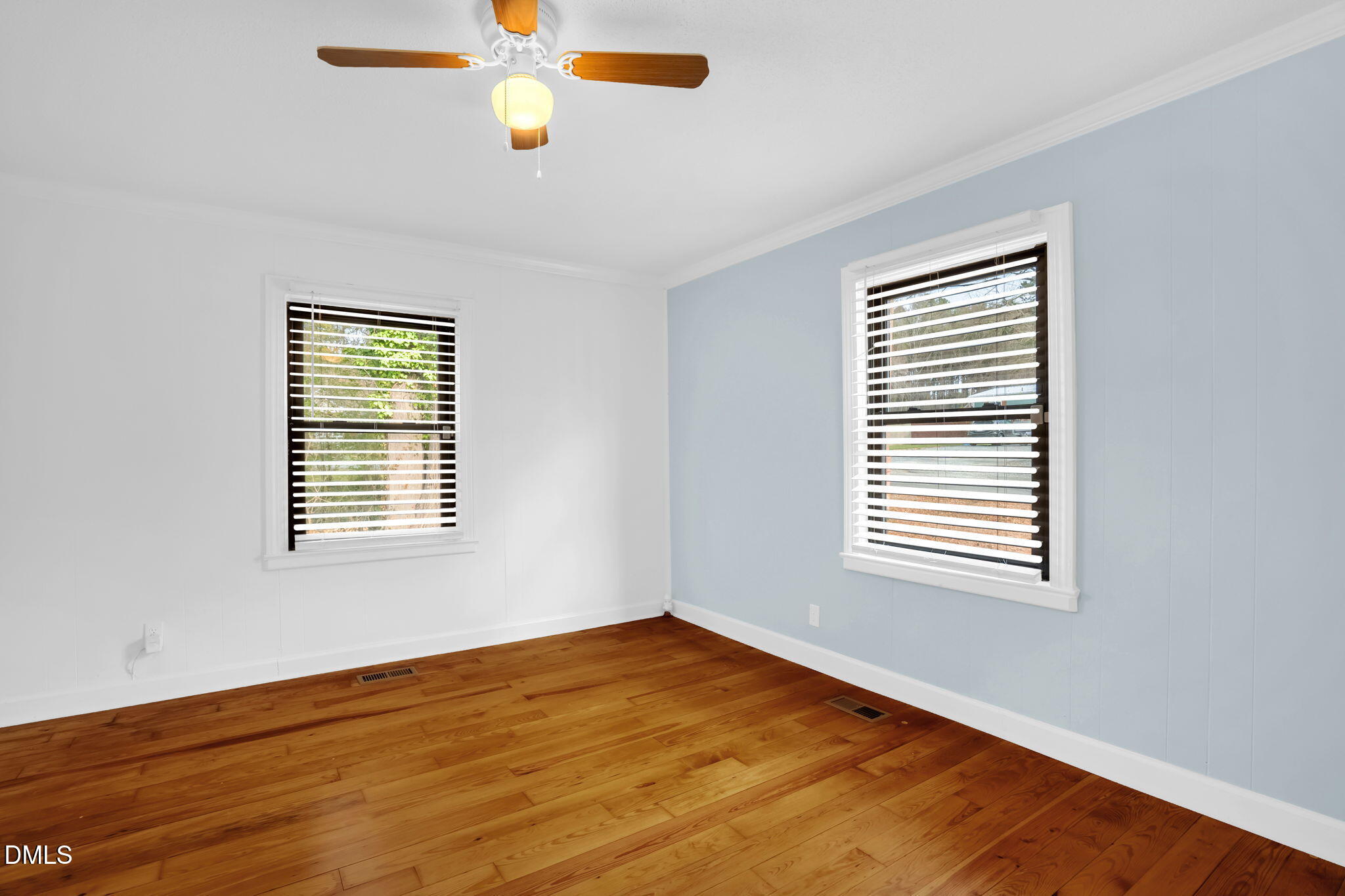 2807 Beck Road Durham, NC 27704 - Photo 9 of 35 a view of an empty room with wooden floor and a window