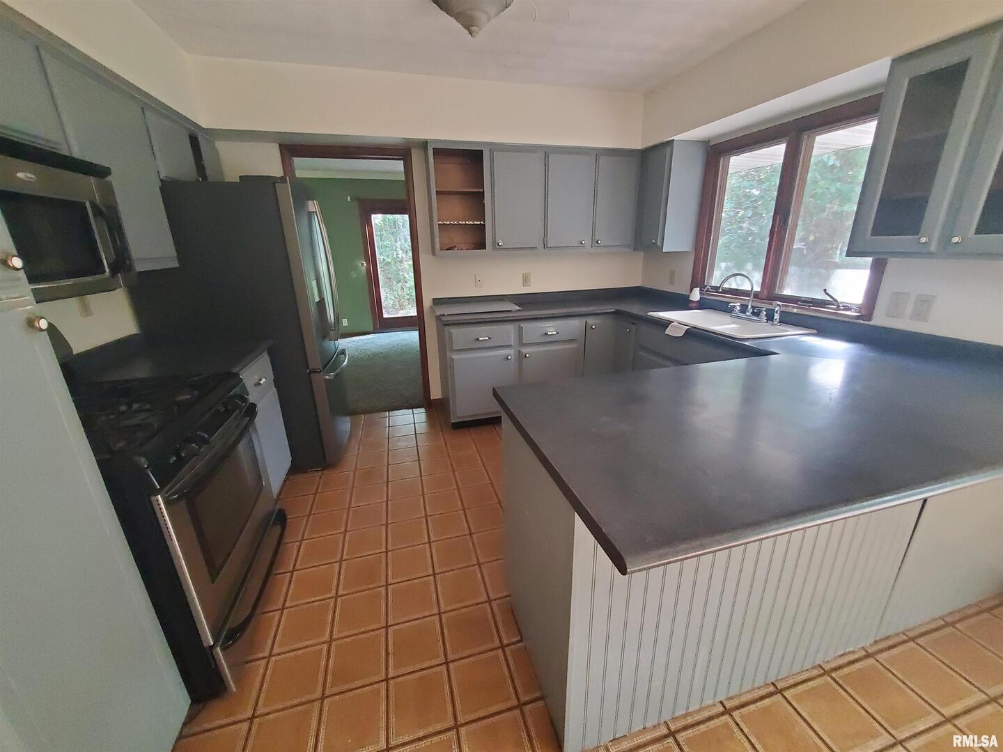 1637 Harrison Drive Clinton, IA 52732 - Photo 8 of 14 a view of a kitchen with fridge and a sink