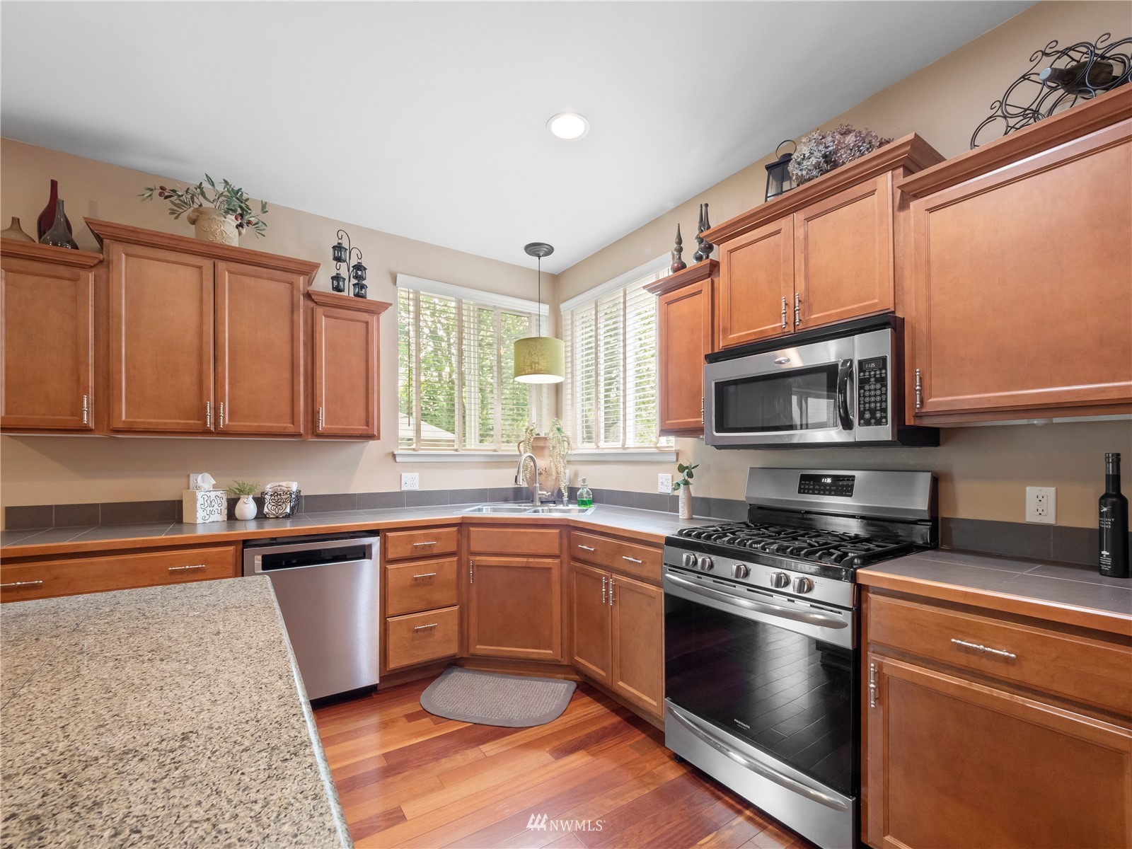 16529 37th Drive Southeast Bothell, WA 98012 - Photo 13 of 40 a kitchen with stainless steel appliances granite countertop a sink a stove a microwave and cabinets