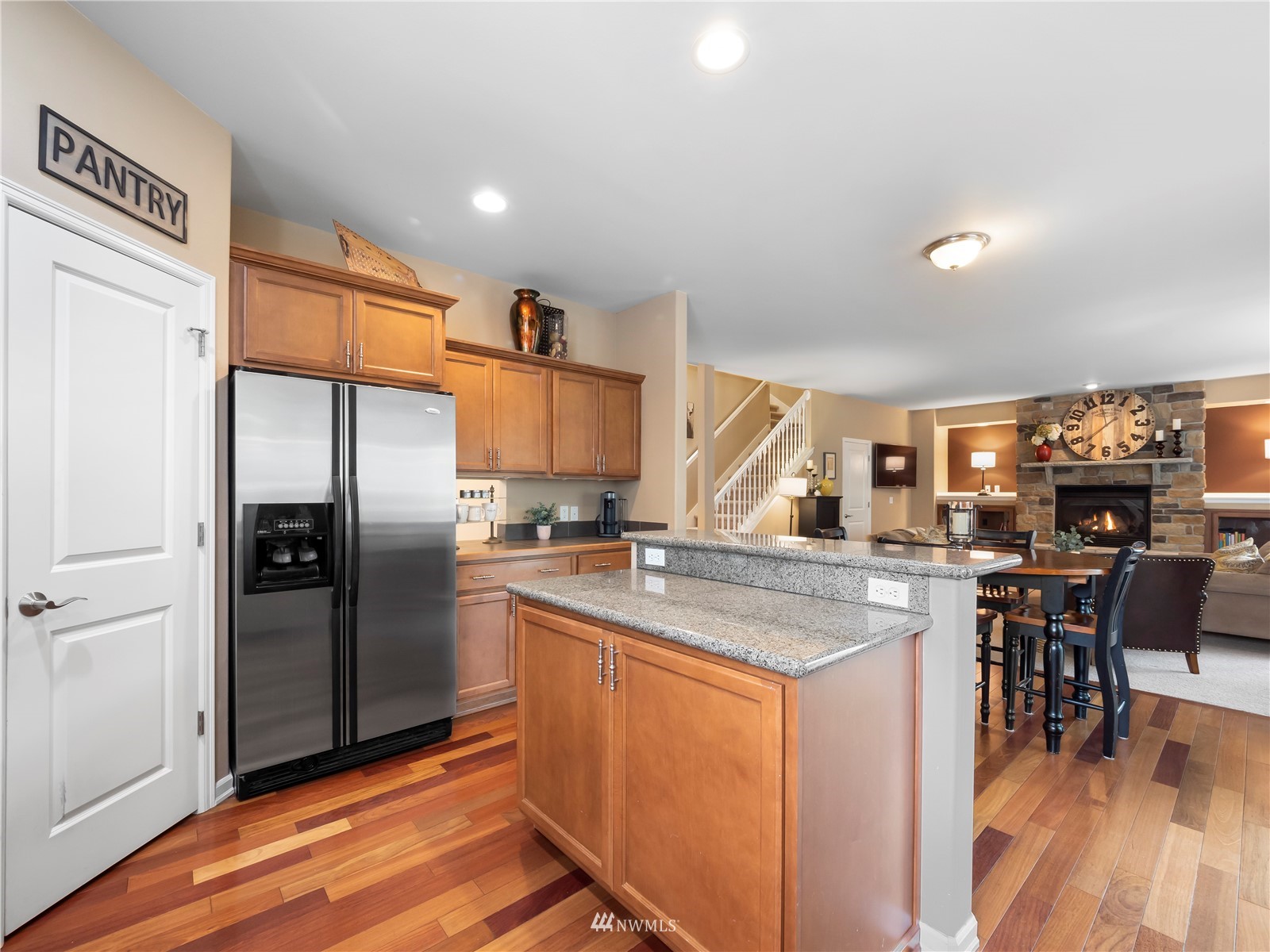 16529 37th Drive Southeast Bothell, WA 98012 - Photo 14 of 40 a kitchen with stainless steel appliances granite countertop a refrigerator a stove a sink a dining table and chairs with wooden floor