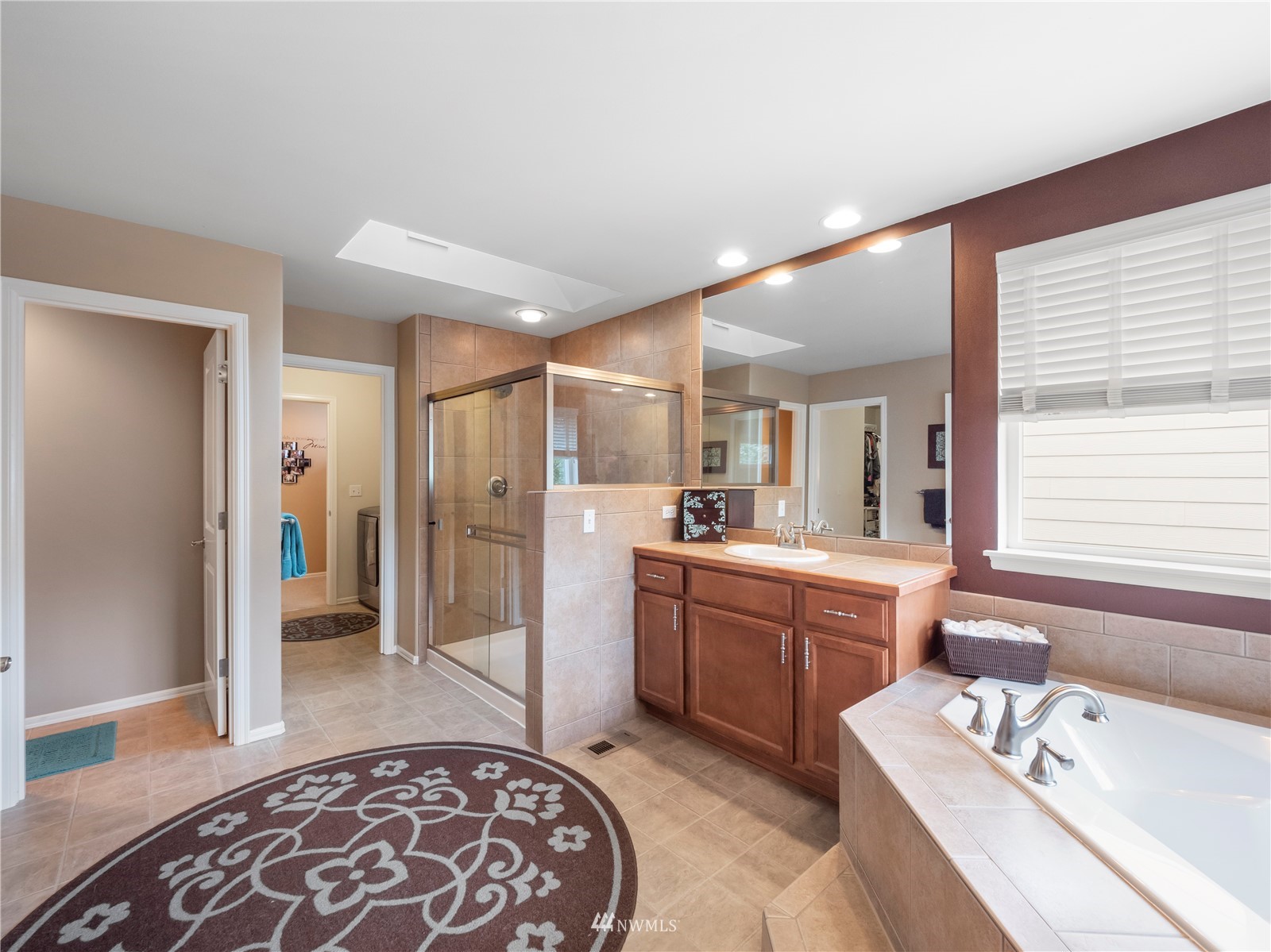 16529 37th Drive Southeast Bothell, WA 98012 - Photo 27 of 40 a large bathroom with a tub sink and mirror