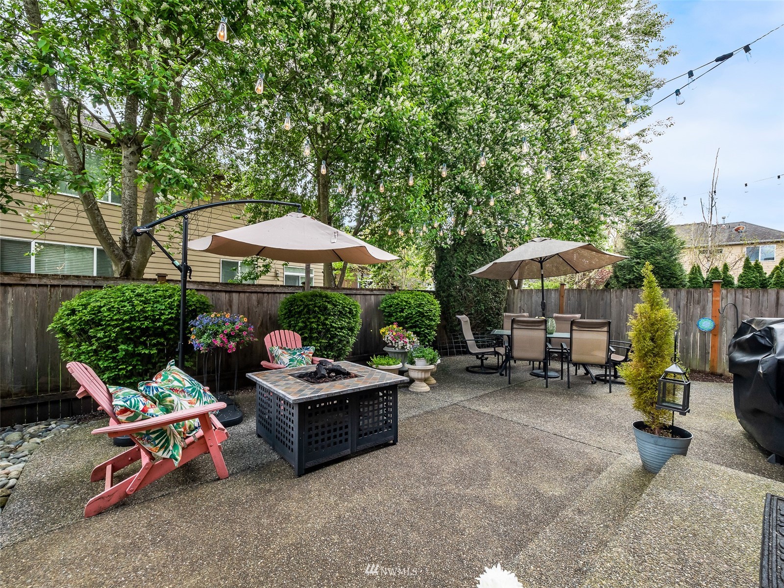 16529 37th Drive Southeast Bothell, WA 98012 - Photo 37 of 40 a view of a patio with a table and chairs under an umbrella