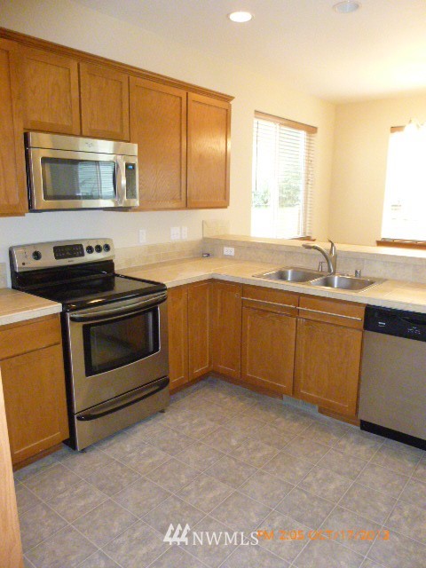 4120 150th Street Southeast Bothell, WA 98012 - Photo 6 of 16 a kitchen with a sink stove and microwave