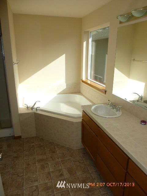 4120 150th Street Southeast Bothell, WA 98012 - Photo 9 of 16 a bathroom with a tub sink and mirror