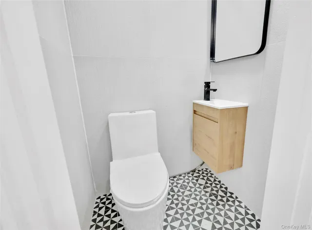 a white toilet sitting next to a white sink