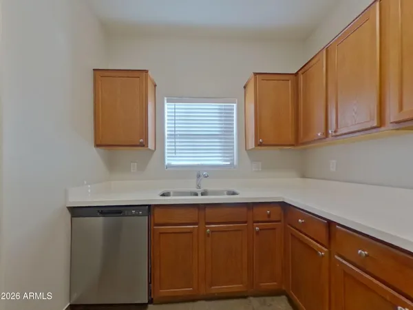 a kitchen with granite countertop cabinets sink and window