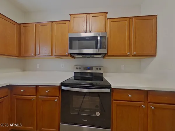 a kitchen with a refrigerator and a microwave