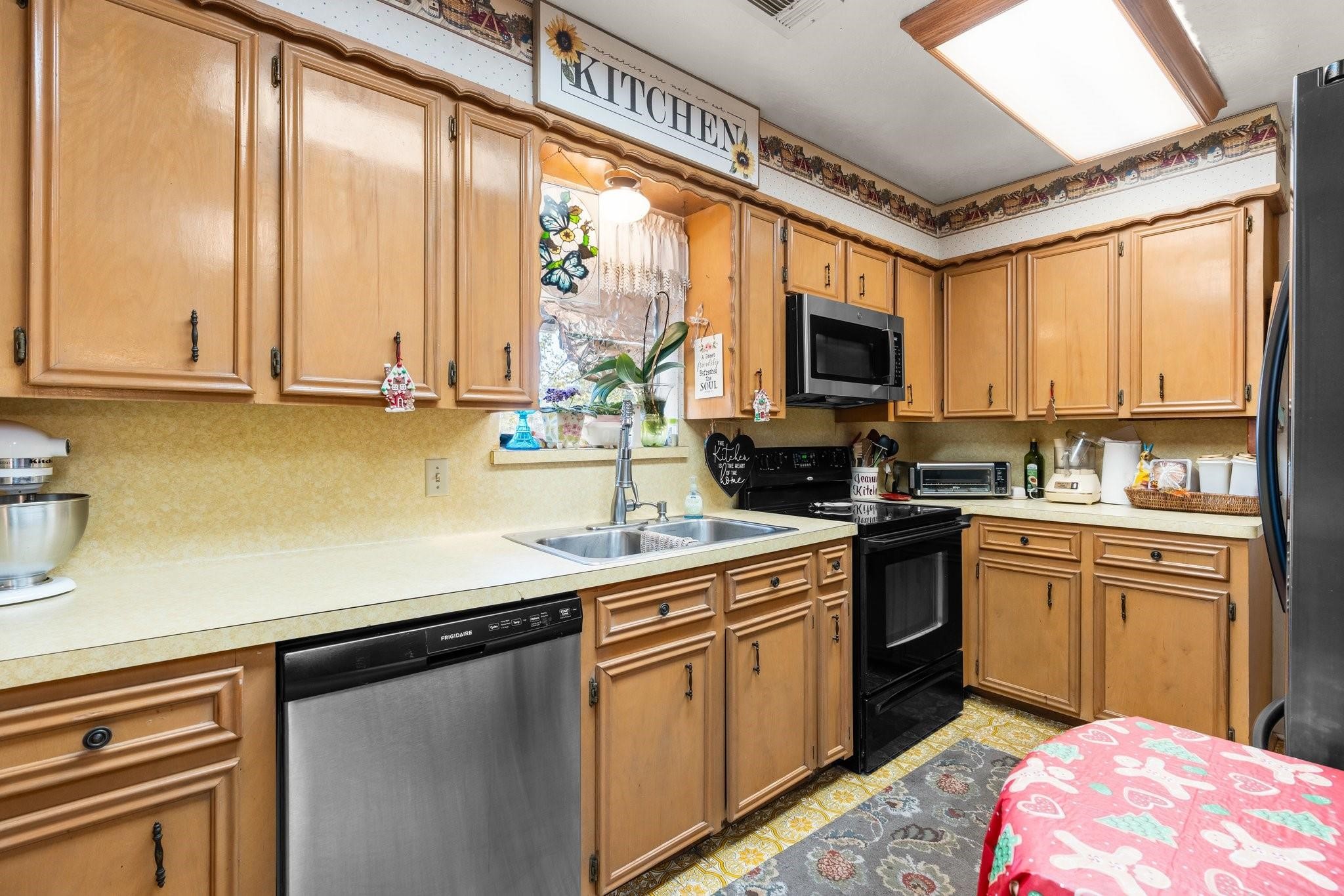 15091 Farm To Market 1485 Conroe, TX 77306 - Photo 8 of 28 a kitchen with a sink stove and cabinets