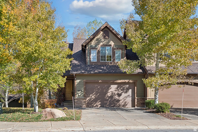 3026 Lower Saddleback Road Park City, UT 84098 - Photo 2 of 71 View of front of house featuring stone siding, driveway, an attached garage, and a shingled roof