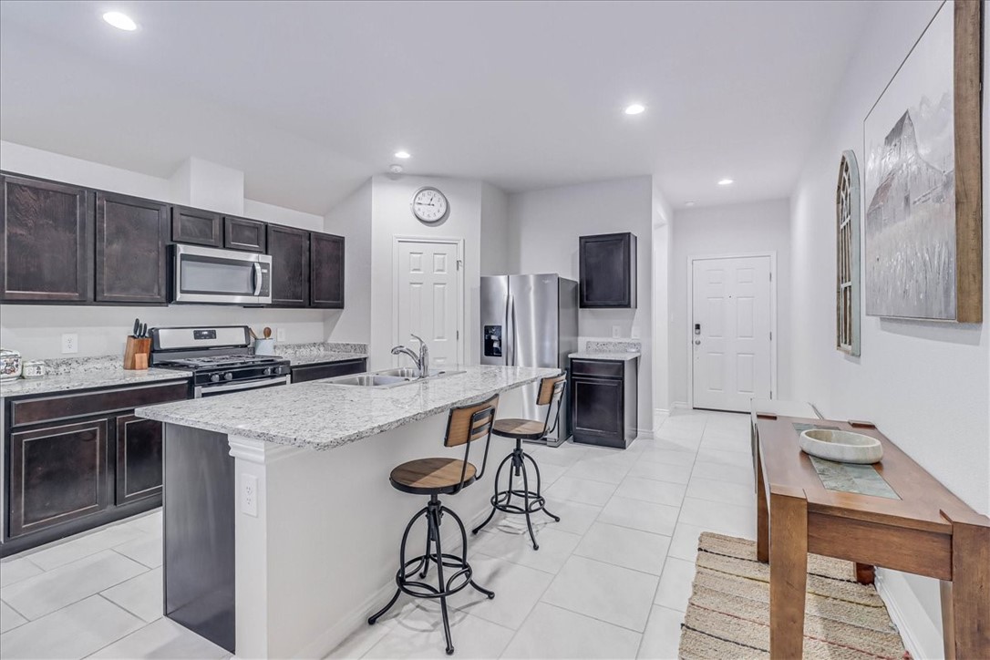 2321 Tranquil Lane Corpus Christi, TX 78418 - Photo 4 of 40 a kitchen with a sink stainless steel appliances and cabinets