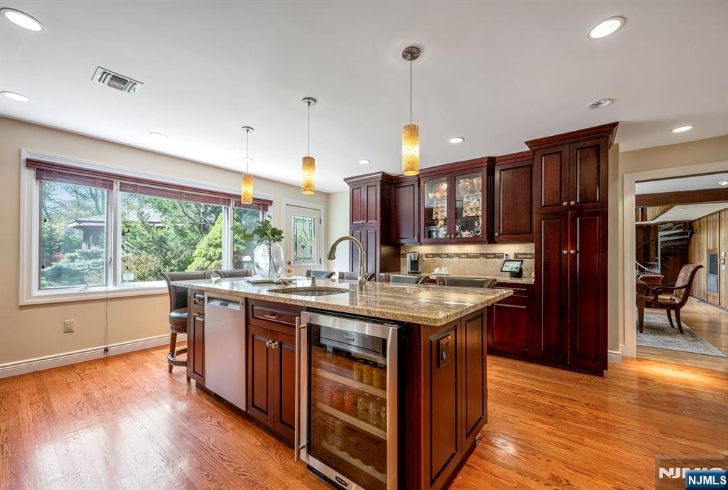 84 Bogerts Mill Road Harrington Park, NJ 07640 - Photo 12 of 47 a kitchen with kitchen island granite countertop a stove and a wooden floors