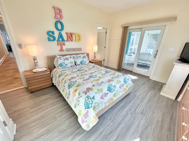 a bedroom with a bed and painting on the wall