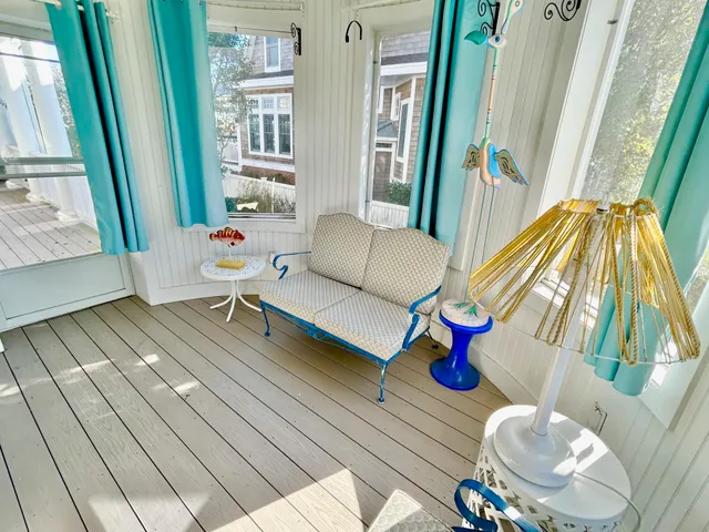 a living room with furniture and a floor to ceiling window