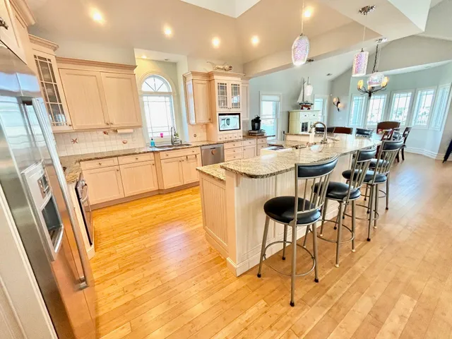 a large kitchen with a table and chairs in it