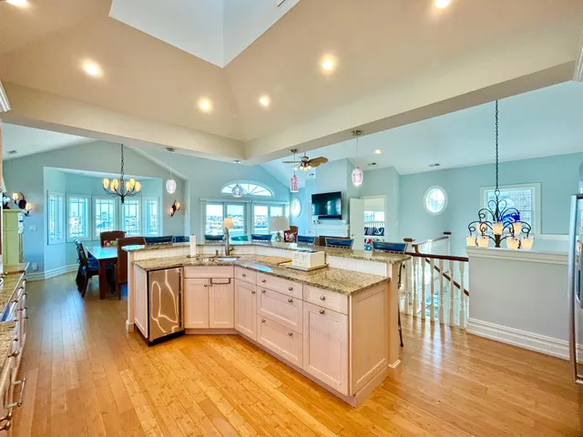 a large kitchen with lots of counter top space and stainless steel appliances