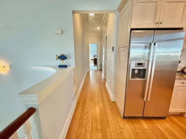 a walk in closet with wooden floor