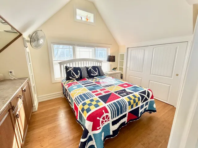 a bedroom with a bed and a window