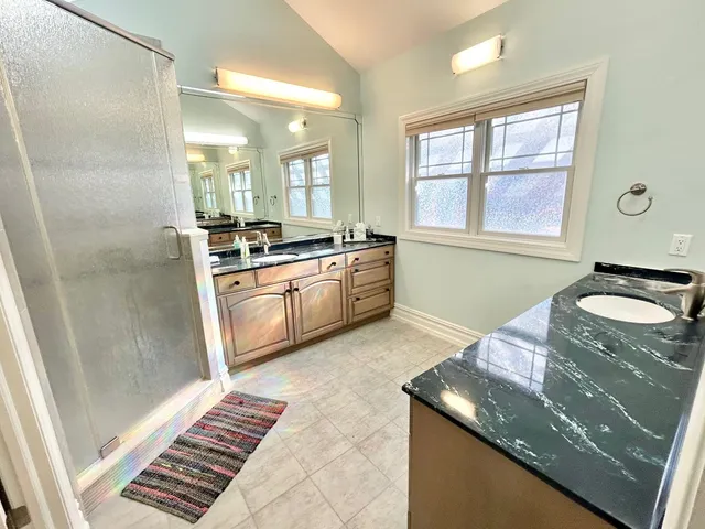 a kitchen with granite countertop stainless steel appliances a sink stove and a window