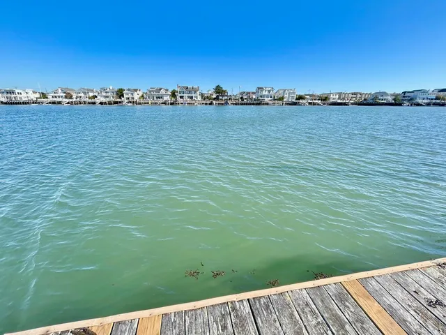 a view of a terrace with couches and ocean view