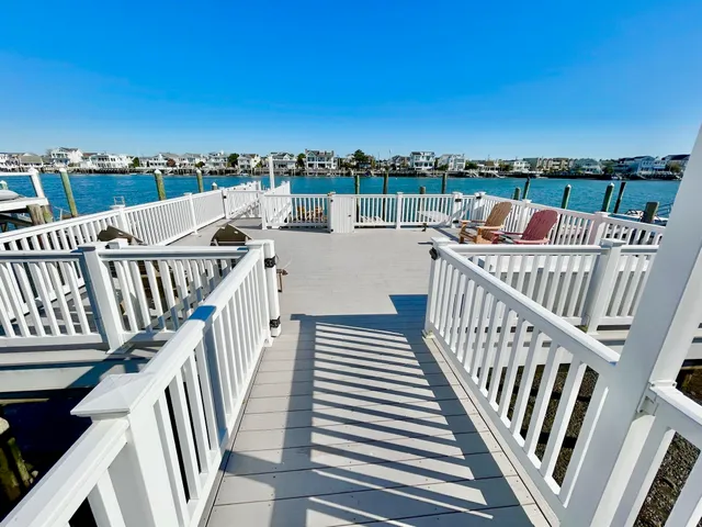 a view of roof deck with a table and chairs