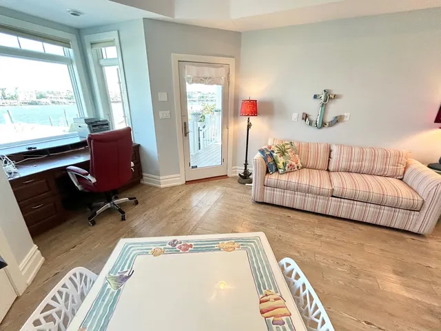a living room with furniture rug and window