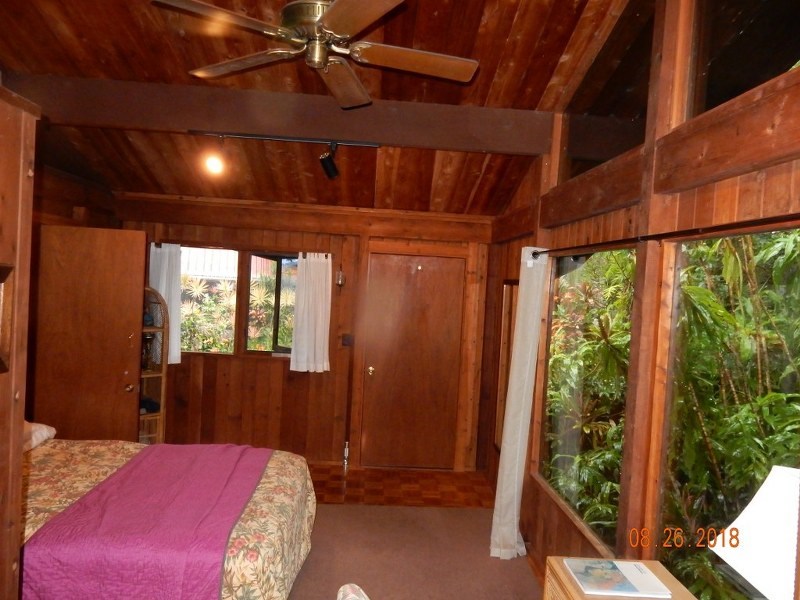 141 Kapuai Road Haiku, HI 96708 - Photo 12 of 15 a bedroom with a bed and a large window