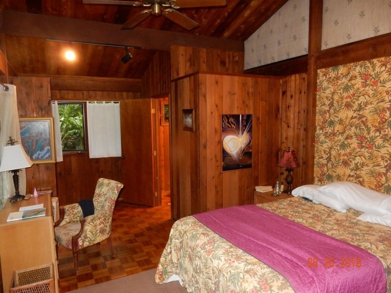 141 Kapuai Road Haiku, HI 96708 - Photo 13 of 15 a bedroom with a bed and a chair