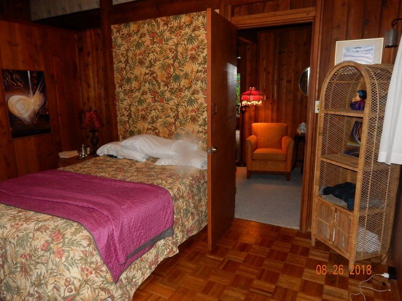 141 Kapuai Road Haiku, HI 96708 - Photo 14 of 15 a bedroom with a bed and wooden floor