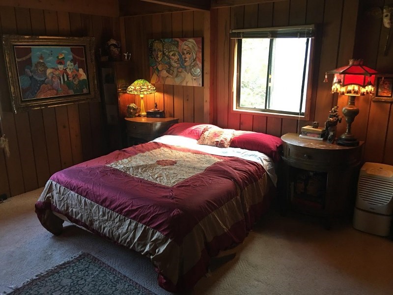 141 Kapuai Road Haiku, HI 96708 - Photo 3 of 15 a bedroom with a bed and dresser with mirror
