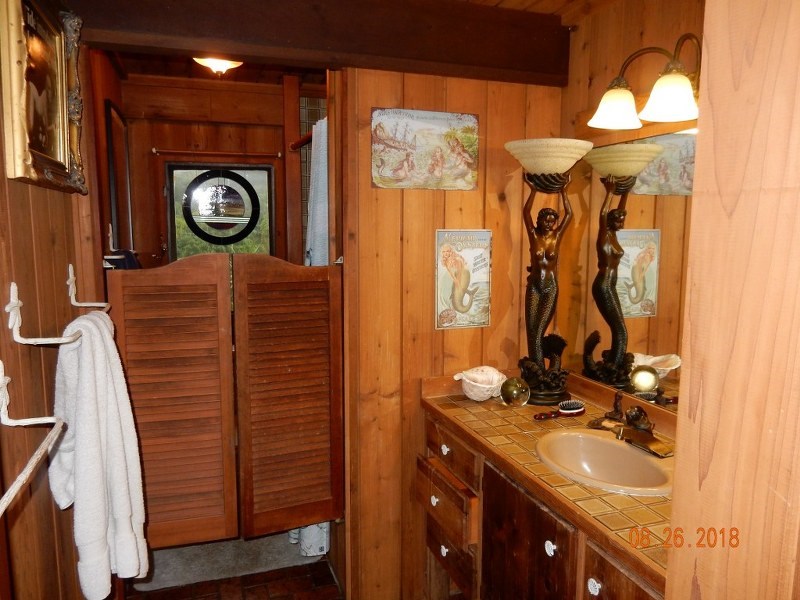 141 Kapuai Road Haiku, HI 96708 - Photo 7 of 15 a bathroom with a sink a mirror and a shower