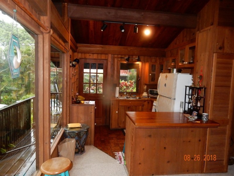 141 Kapuai Road Haiku, HI 96708 - Photo 8 of 15 a room with wooden floor and furniture