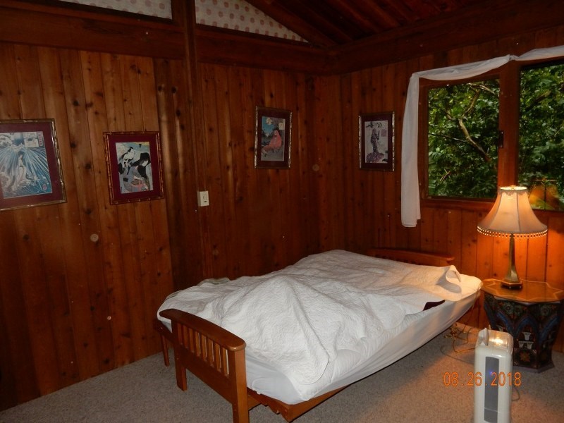 141 Kapuai Road Haiku, HI 96708 - Photo 10 of 15 a bed sitting in a bedroom next to a window
