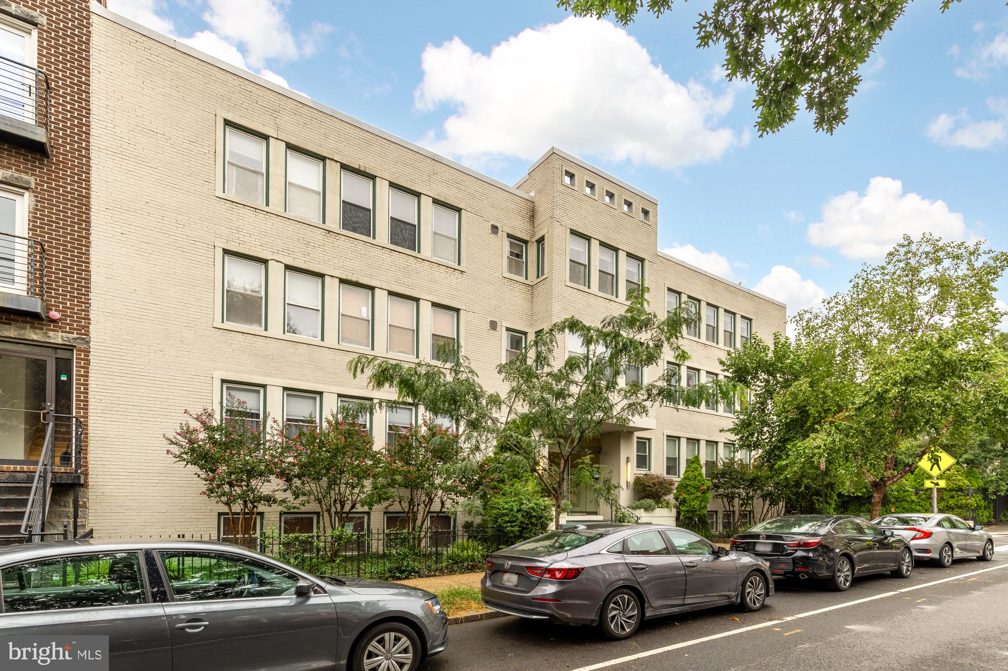 a view of cars parked in front of a building