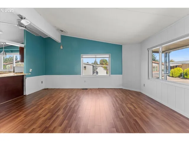 a view interior of a house wooden floor windows and a fireplace