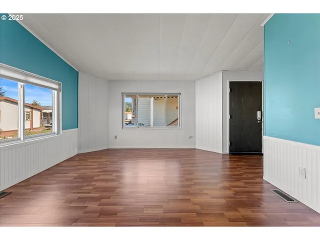 a view of a room with wooden floor and cabinet