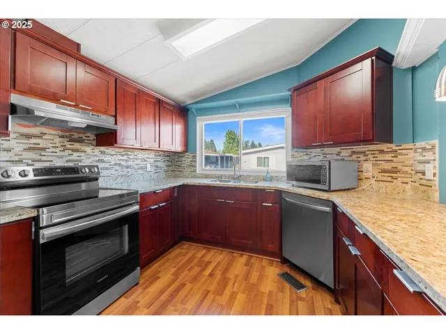 a bathroom with a sink a stove and a mirror