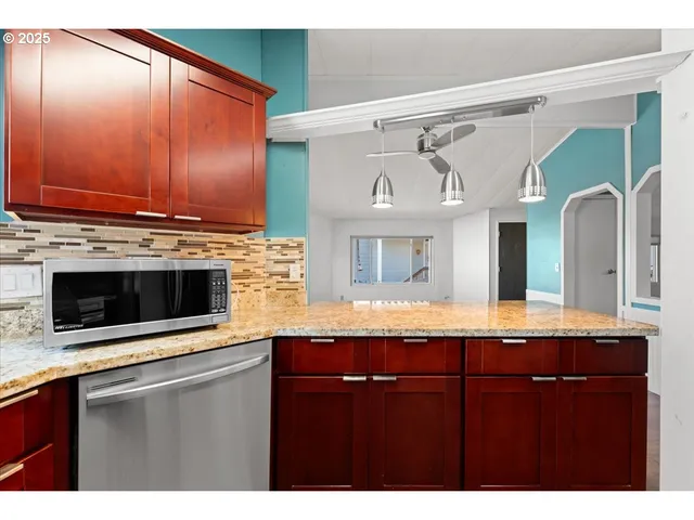 a view of kitchen with granite countertop cabinets and wooden floor
